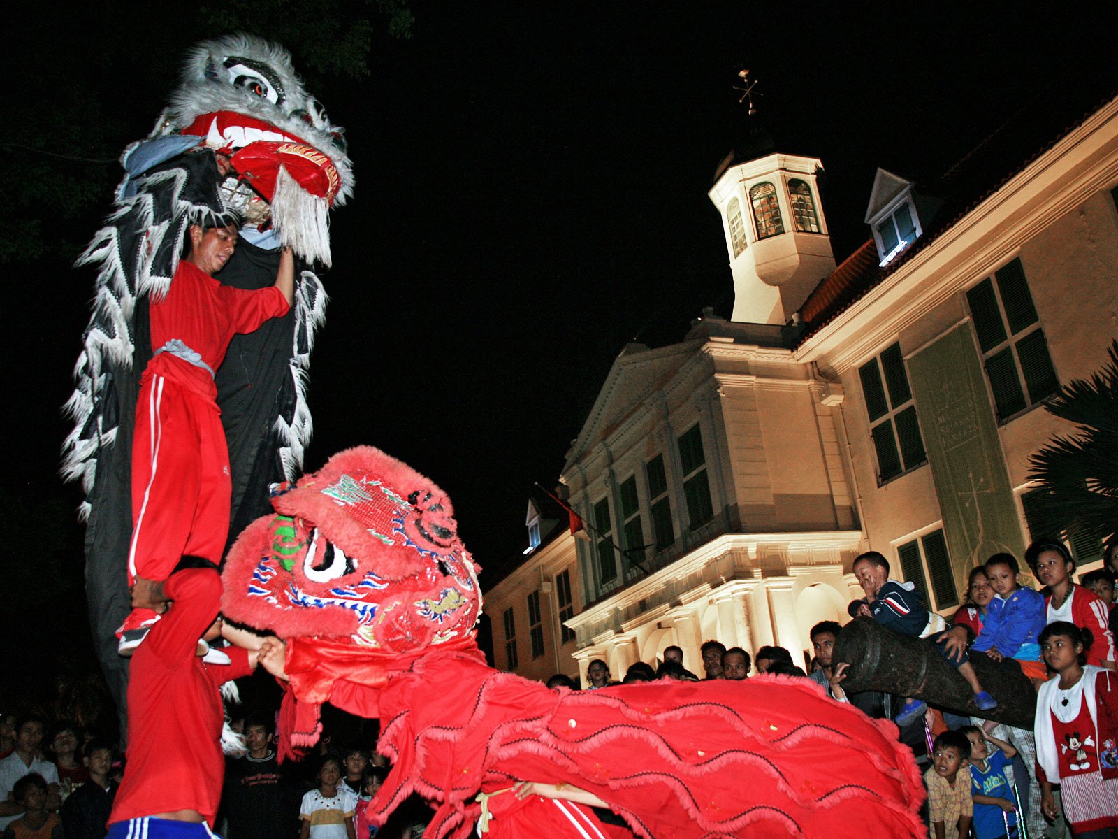 A group of barongsai (lion dance) performers play in front of the Fatahillah Park in Jakarta. Presidential Instruction No. 14/1967 on Chinese Religions, Beliefs, and Traditions once prohibited Chinese-Indonesians from practicing religious and cultural traditions rooted in their ancestral heritage, including barongsai. Even after the instruction was officially revoked by Presidential Decree No. 6/2000, the discriminatory policy has left many young Chinese-Indonesians disconnected from their cultural identity. Photo: Ricky Yudhistira/Project Multatuli