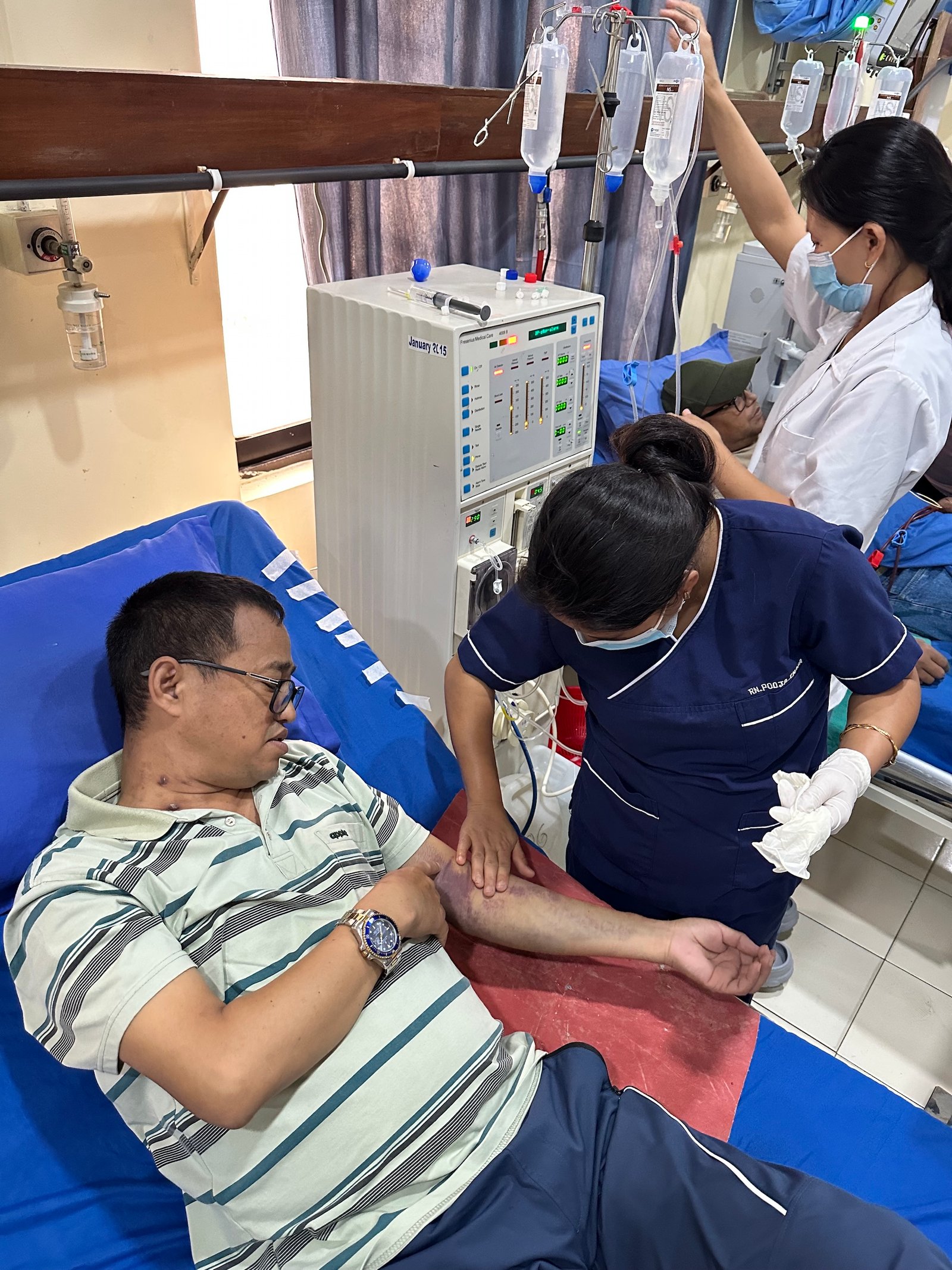 A nurse looking for a vein to inject the needle at Kathmandu’s National Kidney Center. 