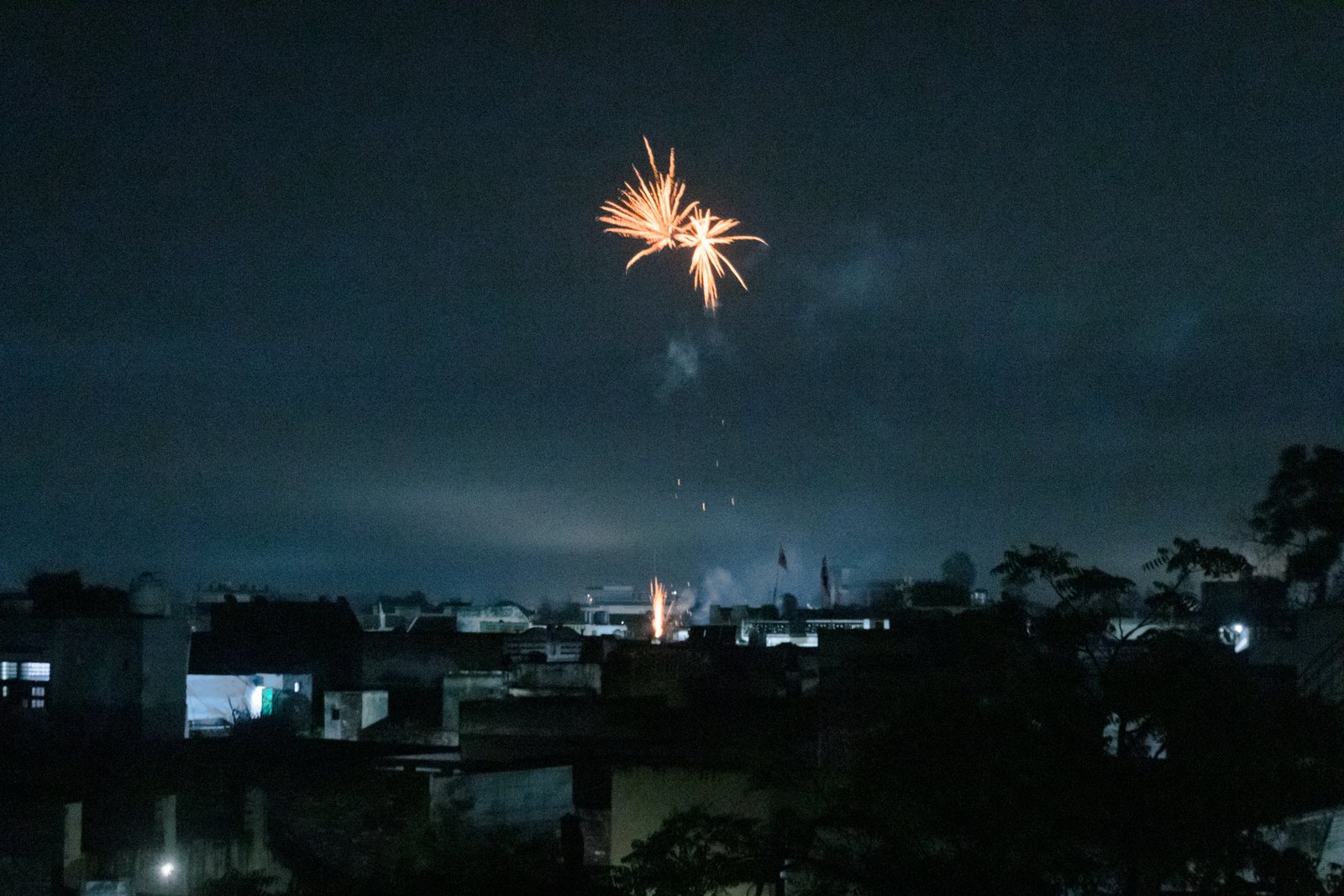 This image shows firecrackers being burst by family members of those who have reached their destination via the dunki route.