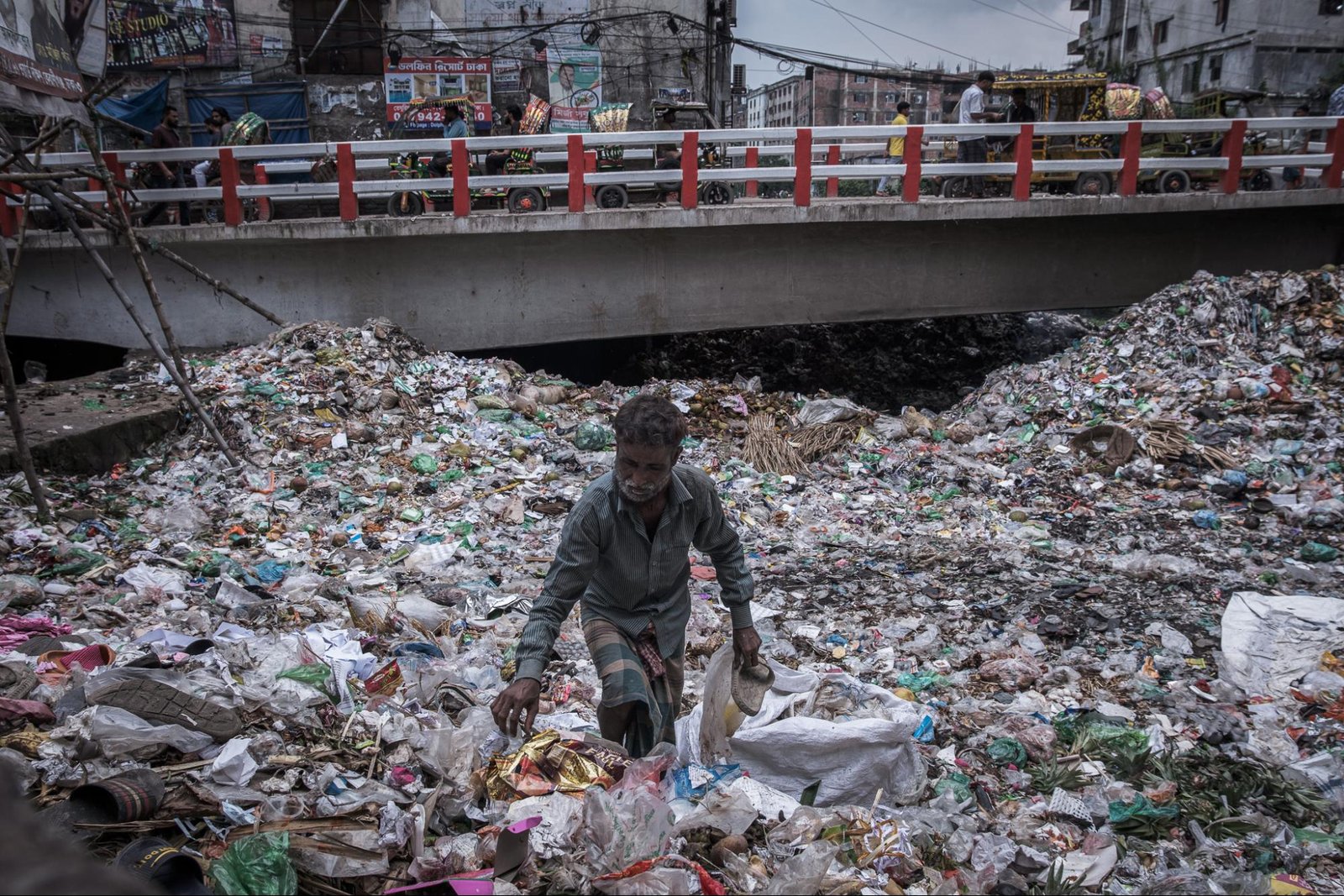 This is an image of a man collecting shoes in Southern Dhaka.