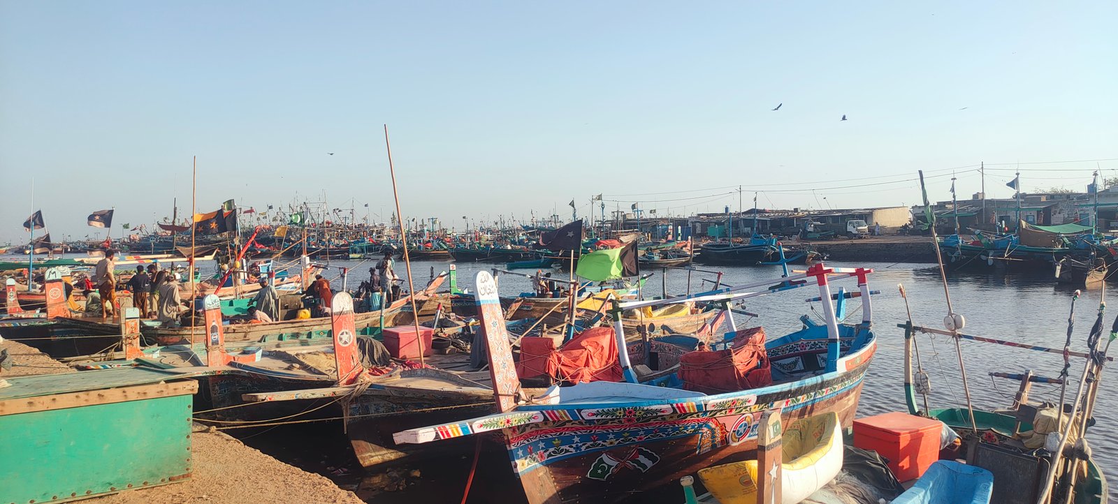 The image shows boats docked in Ibrahim Hyderi.